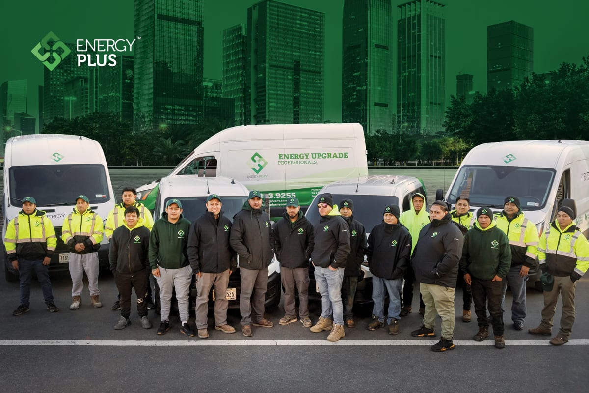 The Energy Plus team in front of their branded service vehicles
